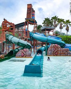 a water park with slides and people swimming in the pool