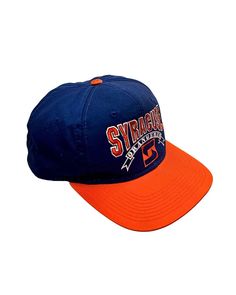 an orange and blue baseball cap with the word syragus on it's side