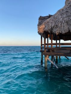 an over head view of the ocean with a hut on it's dock in the foreground