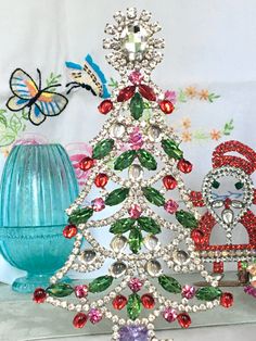 a christmas tree made out of swaroons and other jeweled objects on a table