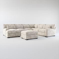 a large sectional couch and ottoman on a white background with no one around it,