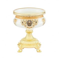 a gold and white vase sitting on top of a table