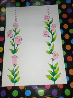 a sheet of paper with pink flowers on it and green leaves painted on the side