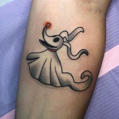 a woman's arm with a cartoon character tattoo on it