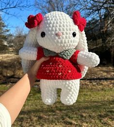 a crocheted white and red stuffed animal