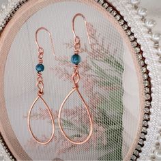 Beautiful Hammered Copper Wire Wrapped Earrings Featuring Blue River Shell Beads 20 And 18 Gauge Tarnish Resistant Copper 4mm River Shell Beads Overall Length Approximately 2.5” These Are Handcrafted And Each One Will Have Subtle Differences Copper Represents The Goddess Of Love Copper Is Said To Attract Good Luck And Money These Earrings Have A Sassy Swing And Will Look Great With Long Or Short Hair New Handmade In My Atlanta Jewelry Studio Be Sure To Check Size Before Purchasing Please Let Me Blue Copper Wire Wrapped Earrings, Copper Beaded Teardrop Earrings For Gifts, Teardrop Copper Beaded Earrings For Gift, Blue Wire Wrapped Bohemian Teardrop Earrings, Blue Bohemian Teardrop Earrings With Wire Wrapped, Bohemian Blue Wire Wrapped Teardrop Earrings, Blue Round Bead Copper Jewelry, Blue Copper Round Bead Jewelry, Blue Copper Round Beads Jewelry