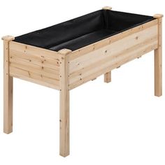 a wooden raised garden bed with black liners