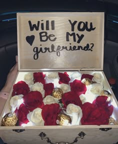 a wooden box with red and white flowers inside that says will you be my girlfriend?