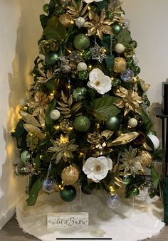 a christmas tree decorated with green and gold ornaments