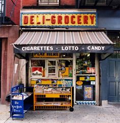 a store front with the name deli grocery on it's side