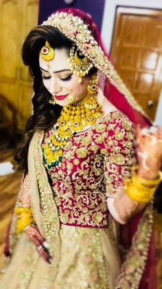 a woman in a bridal outfit is holding something