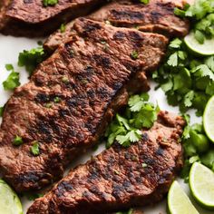 grilled steak with cilantro and limes on a plate