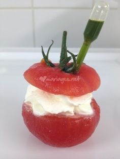 a tomato with cream cheese on it and a toothbrush sticking out of the top