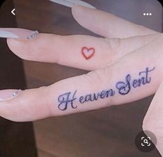 two fingers with the words heaven sent tattooed on them