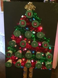 a christmas tree made out of wine corks with letters and numbers on the top