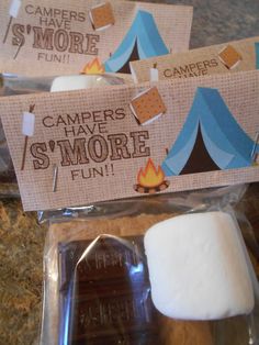 some marshmallows are sitting next to a camper's tent sign