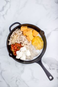 an iron skillet filled with different types of food