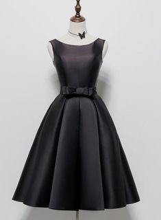 Elevate your evening wear with our Classic Midnight Black Satin Cocktail Dress, a timeless piece that exudes sophistication and style. This elegantly designed dress features a sleek, form-fitting bodice and a flared skirt that creates a striking silhouette. The high-quality satin fabric adds a luxurious sheen and smooth feel, perfect for any formal or semi-formal occasion.The dresss simple yet impactful design is accentuated with a subtle waist belt, offering a cinched look that enhances the nat Party Dress Black Short, Black Short Prom Dress, Black Prom Dress Short, Short Graduation Dresses, Party Dress Black, Short Noir, Corset Dress Prom, Black Satin Dress, Black Prom Dress