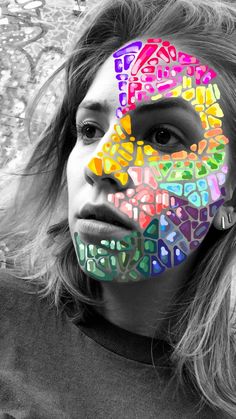 a woman with her face painted in different colors and letters on it's face