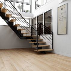 there is a stair case next to the window in this room with wood flooring