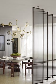 an elegant dining room with glass partitions