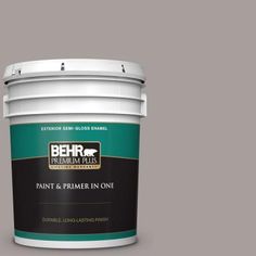 a bucket of behr paint and primer in one, on a blue background