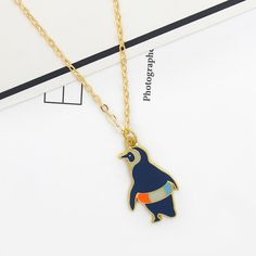 Introducing the Gold Penguin Necklace: A Nautical Treasure Get ready to embark on a nautical adventure with our exquisite Gold Penguin Necklace. This stunning piece is a part of our Nautical Necklaces and Penguin Necklace collections, tailored specially for passionate lovers of the sea and its various symbols. Crafted with care, this necklace is perfect for anyone seeking a touch of elegance and a love for marine animals. Features of the Gold Penguin Necklace based on Specifications Style: Vinta Nautical Style Metal Jewelry Gift, Blue Anchor Shaped Jewelry Gift, Nautical Style Anchor Jewelry In Blue, Blue Nautical Anchor Jewelry, Blue Nautical Style Anchor Jewelry, Blue Nautical Jewelry For Gift, Blue Nautical Style Jewelry For Gift, Blue Nautical Style Jewelry Gift, Penguin Necklace