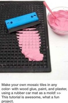 a pink and blue object sitting on top of a metal grate next to a cup