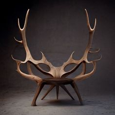 a wooden chair with antlers on it