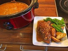 a plate of food next to a slow cooker