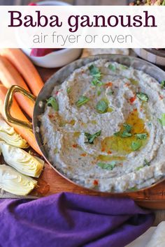 hummus, carrots, celery and other vegetables on a cutting board