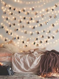 an instagram with pictures hanging on the wall and string lights above it, in front of