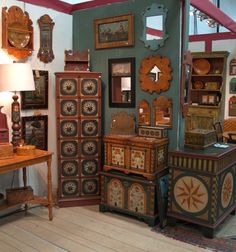 there are many different pieces of furniture on display in this room, including an antique dresser