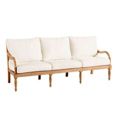 a white couch sitting on top of a wooden frame