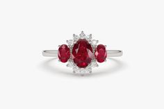 "Ruby Ring / 14k Three Stone Natural Ruby Cluster Ring / Classic Genuine Ruby Engagement Ring 14k Gold / July Birthstone / Promise Ring Features *Made to Order *Gold Kt: 14K (also available in 18K) *Available Gold Color: Rose Gold, Yellow Gold, White Gold *Oval Shape Ruby: 1 pc 6 x 4MM *Oval Shape Ruby: 2 pc 4x3MM *Round Diamonds: 10 pcs 1.55 MM *Ruby CTW: 1.23 ctw *Diamond CTW: 0.16 ctw *Ready to Ship in 7-10 Business Days If you have any additional questions about this product, just hit the \" Classic Red Three Stone Rings, Classic Red Three-stone Ring, Elegant Three Stone Red Diamond Ring, Elegant Three-stone Red Diamond Ring, Elegant Red Three Stone Diamond Ring, Elegant Red Three-stone Diamond Ring, Fine Jewelry 14k White Gold Three Stone Ring, 14k White Gold Three Stone Ring Fine Jewelry, 14k White Gold Three Stone Ring