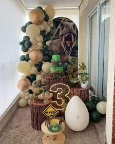 a dinosaur themed birthday party with balloons and decorations