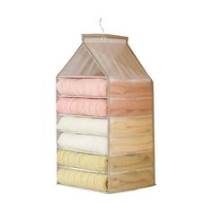 a stack of folded towels sitting on top of a wooden shelf