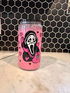 a pink cup with a cartoon character painted on it