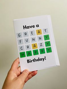 someone holding up a birthday card with the words have a great crazy happy birthday on it