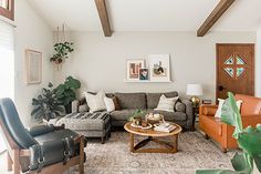 a living room filled with furniture and plants