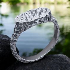 Embrace bold design with our Industrial Brutalist Hammered Ring, a unique piece of artisan jewelry that blends rugged charm with modern style. Crafted from solid silver, this rustic signet ring is perfect for both men and women who appreciate an edgy, industrial aesthetic. The hammered finish adds texture and depth, making it an ideal accessory for casual wear or as a rustic wedding ring. Whether you're drawn to industrial, brutalist, or artisan design, this ring is a timeless statement of indiv Silver Ring For Men, Rustic Wedding Rings, Industrial Aesthetic, Hammered Ring, Hammered Rings, Mens Silver Rings, Ring For Men, Modern Women, Artisan Design