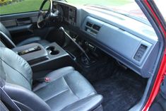 the interior of a car with black leather seats