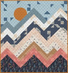 a quilt with mountains and trees on it