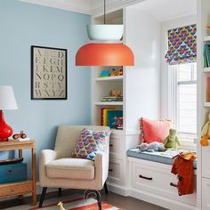 a child's room with blue walls and white furniture