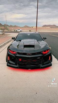 the chevrolet camaro is parked on the side of the road