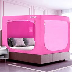 a bed with a pink canopy over it in a room that has white walls and flooring