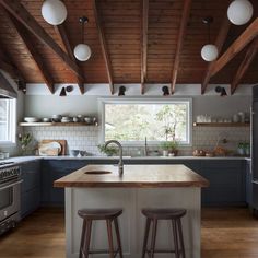 two stools sit at the center of a kitchen island