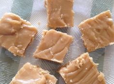 several pieces of peanut butter sitting on top of a glass plate