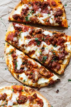 three slices of pizza sitting on top of a piece of wax paper