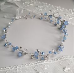 a close up of a necklace on a lace table cloth with beads and glass beads